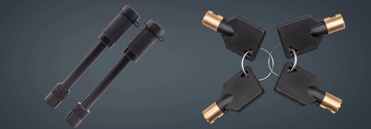 Two black YakJak OneKey locking pins beside four matching brass-tipped keys.